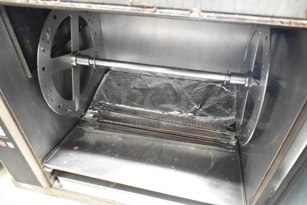 Alto Shaam AR-7E rotisserie oven, stainless steel interior, electric-powered, commercial grade, visible rotisserie mechanism.