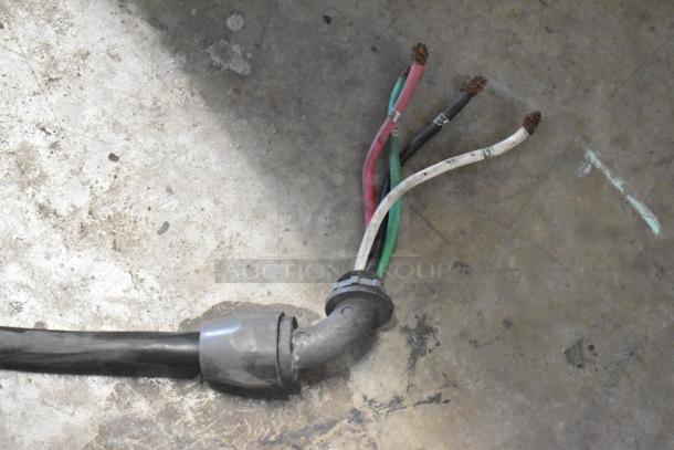 Electrical wiring for Alto Shaam AR-7E Rotisserie Oven, showing multi-colored power cables on a concrete floor.