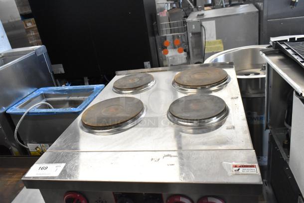 Cookline stainless steel 4-burner electric hot plate range with oven, commercial use. Slight wear visible; warning label intact.