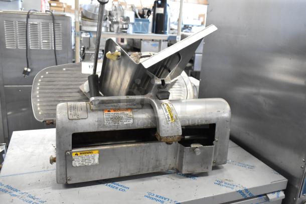 Hobart 1612 stainless steel commercial meat slicer, 115 volts, 1 phase, visible warning labels, used condition.
