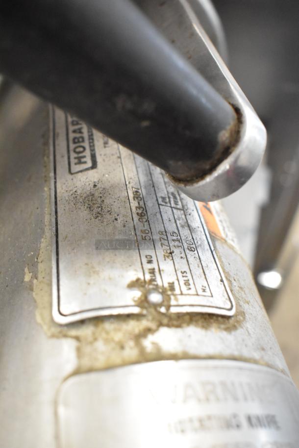 Hobart 1612 stainless steel commercial meat slicer, 115 volts, 1 phase. Visible wear and manufacturer label with model info.