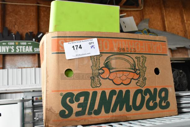 Cardboard box labeled "174, QTY x5" containing paper towel dispenser and soap dispensers, stacked on a shelf.