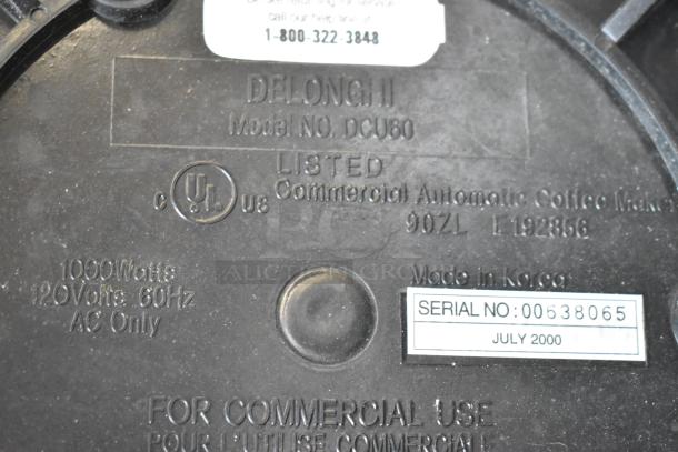 DeLonghi model DCU80 coffee maker label, indicating 1000W, 120V, 60Hz, UL listed, serial number 00638065, made in Korea.