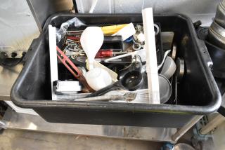 Lot of various items in black poly bus bin, includes utensils, kitchen tools, and assorted metal pieces. Used condition.