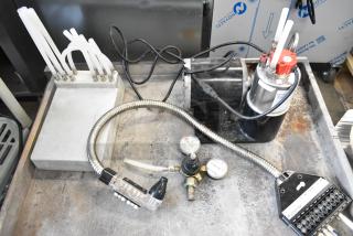 Lot featuring a cold plate and McCann's tank, with hoses and gauges; pre-owned condition, ideal for beverage systems.