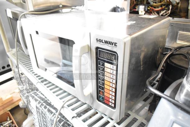 Brand new Solwave 180MW1000SS stainless steel commercial microwave with push-button controls. Minor scratches visible. 120V, 1 Phase.