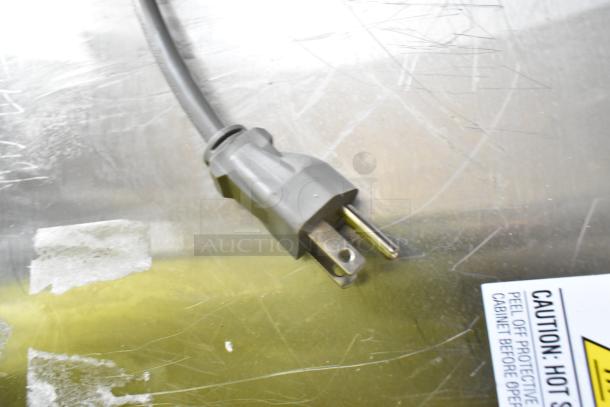 Solwave 180MW1000SS microwave plug and caution label on stainless steel surface; new, with minor scratches.
