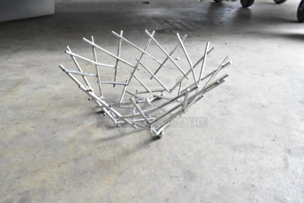 Metal basket with an open lattice design, made of silver metal rods. Part of a lot of 25 various metal baskets.
