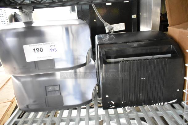3 poly wall mount dispensers for paper towels and toilet paper, black and silver, with visible auction label "190 QTY VX3".