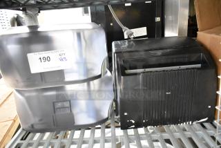 3 poly wall mount dispensers for paper towels and toilet paper, black and silver, with visible auction label "190 QTY VX3".