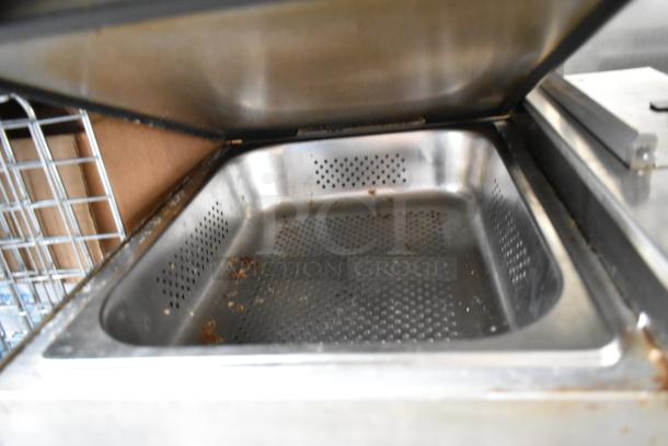 Avantco 177QS1800SS stainless steel countertop steamer, used condition, open lid showing perforated interior.