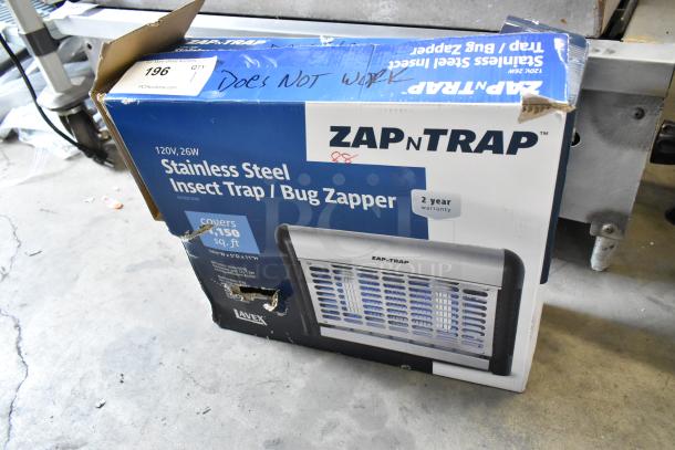 Brand new Zap n Trap Bug Zapper box, 120V, stainless steel, covers 1,500 sq. ft., two-year warranty. Box says "Does Not Work."