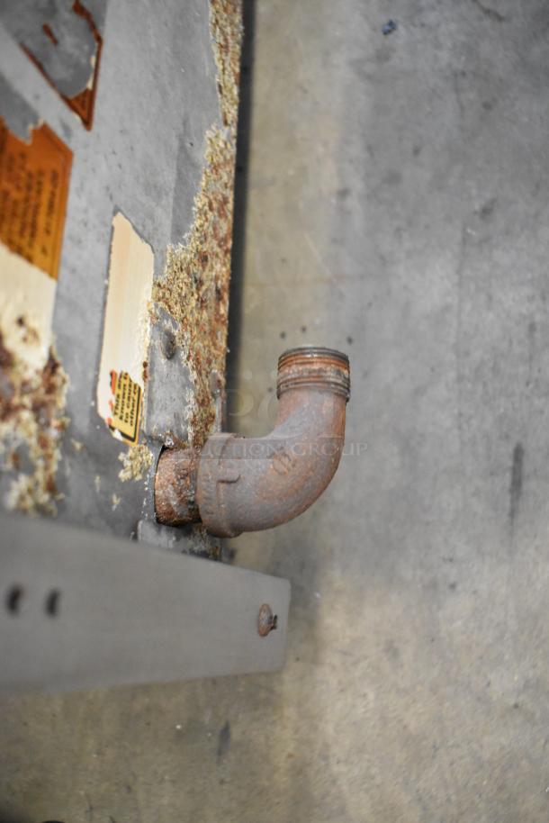 Rusty metal pipe on Vulcan Hart VCOB36 charbroiler, with visible wear and corrosion on stainless steel surface.