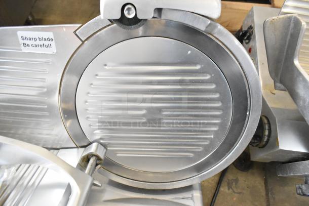 Avantco 177SL312 metal countertop meat slicer with blade sharpener. Includes caution label. 115 volts, 1 phase.