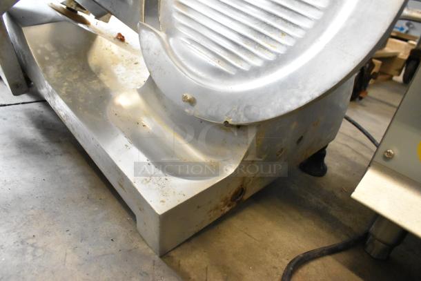 Globe GC12D metal commercial countertop meat slicer with blade sharpener. Shows signs of wear, power cord visible.