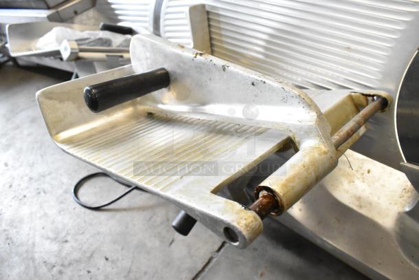 Globe GC12D metal commercial meat slicer with blade sharpener. Visible wear on sliding tray, operates on 115 volts, 1 phase.
