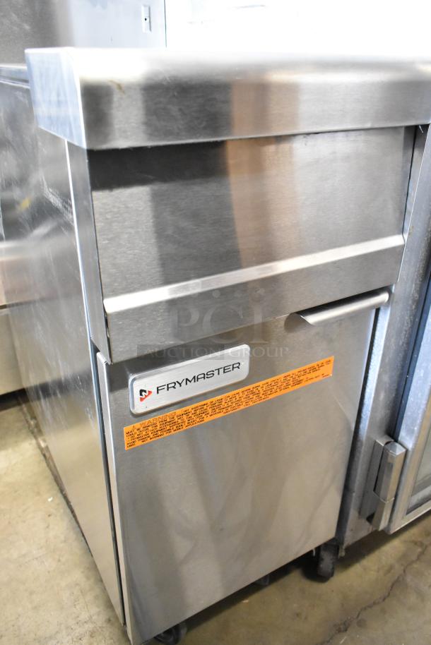 Frymaster stainless steel commercial fryer on casters, featuring a branded label and warning marking, in good condition.