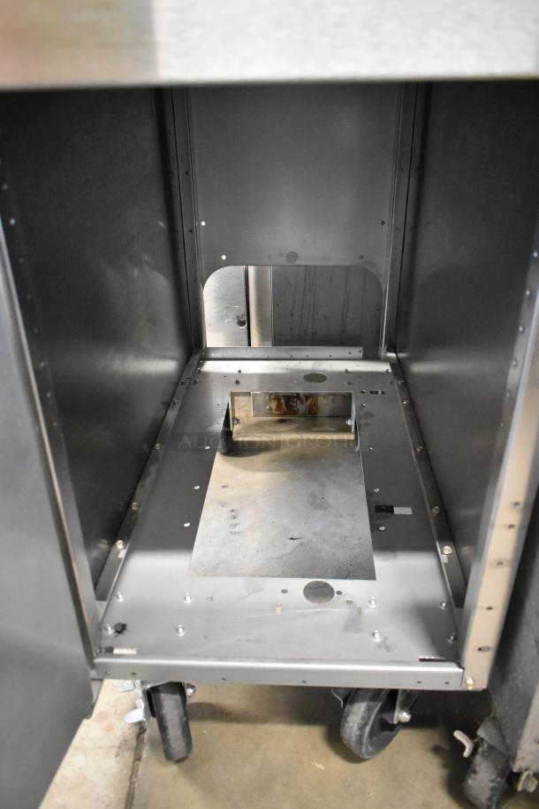 Frymaster stainless steel commercial fryer frame on commercial casters, shown inside view, sturdy construction, used condition.