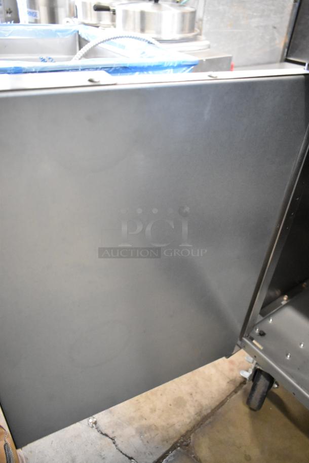 Frymaster stainless steel commercial fryer frame with commercial casters, in good condition, suitable for heavy-duty use.