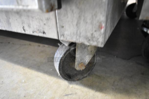 Continental 2RE-GD metal reach-in cooler merchandiser caster. Shows wear, typical for commercial use. 115 Volts, 1 Phase.