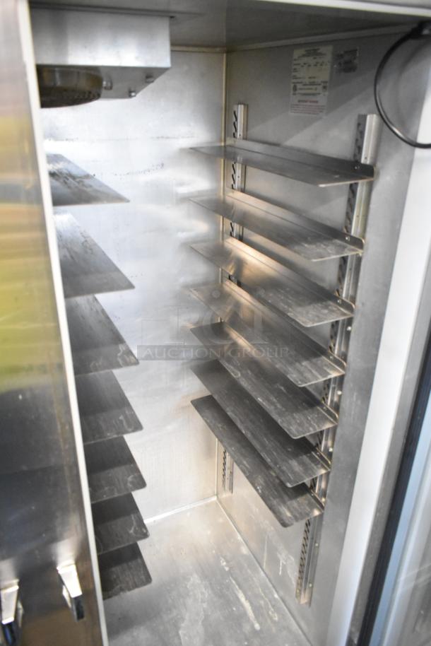Continental 2RE-GD metal commercial 2-door reach-in cooler with adjustable shelves, visible interior space, and commercial casters.