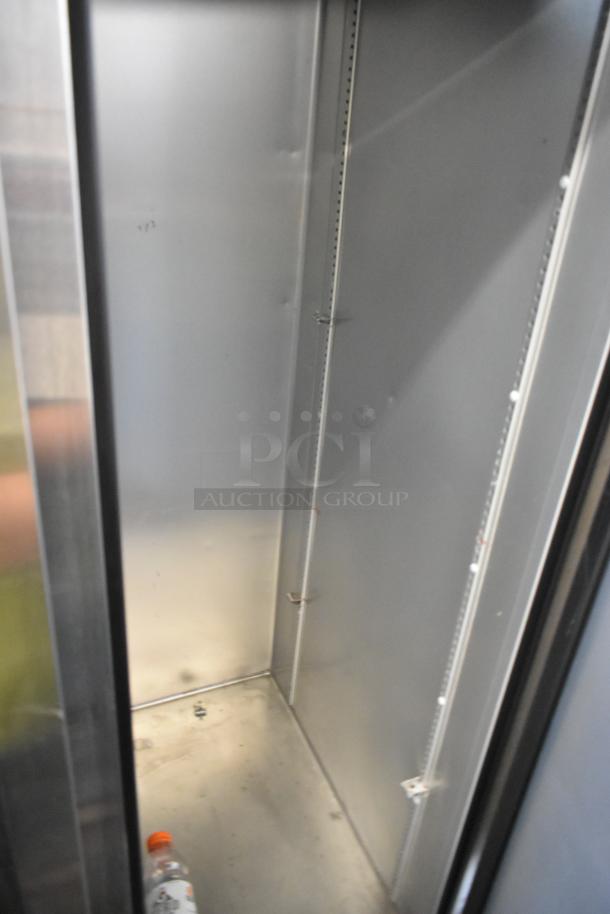 2021 True T-35-HC stainless steel commercial cooler interior, clean, with clear shelving slots, on commercial casters.