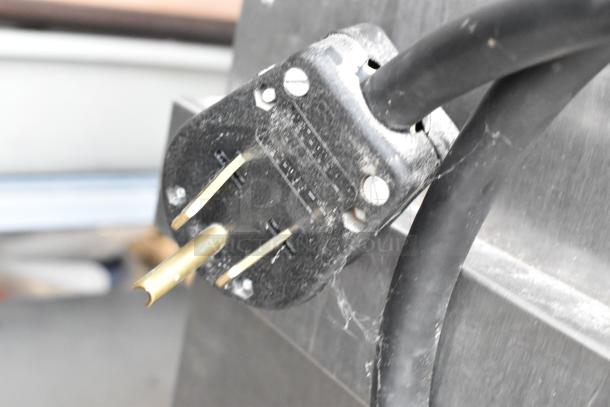 Close-up of Alto Shaam 1200-SK/III smoker oven power plug, showing a slightly worn condition; 208-240V, 1 Phase.