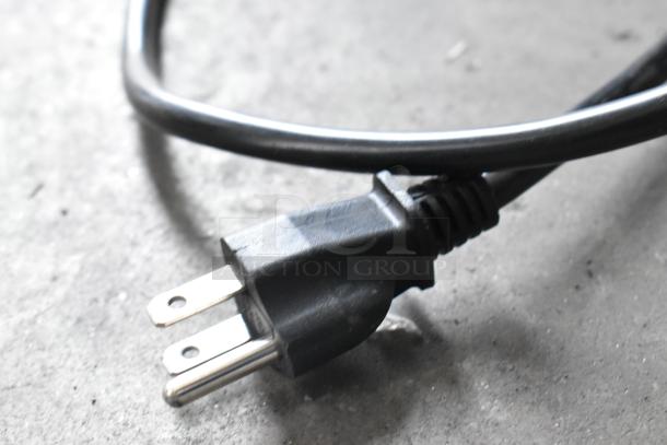Close-up image of a black power cord and plug for the Avantco 177CU100ETL countertop coffee machine, 120V, 1 phase.