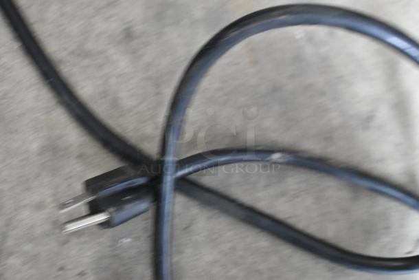 Blurry image of a black electrical cord with a two-prong plug for a Waring CB16N blender. Condition not clear.