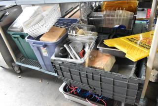 Assorted items in poly bins including utensils, drop-in bins, and a "Wet Floor" sign, all on a cart. Various conditions.