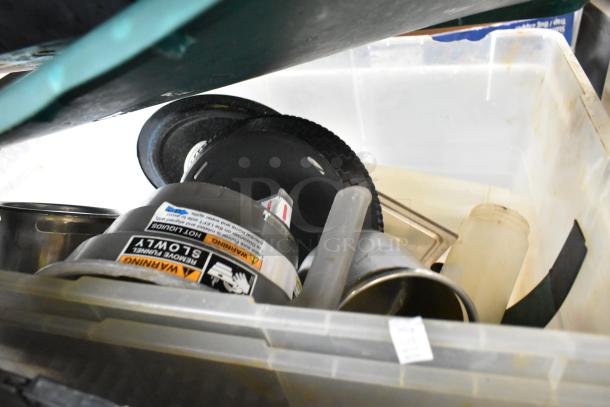 Various items in poly bins including utensils, drop-in bins, and a funnel with caution labels, all in used condition.