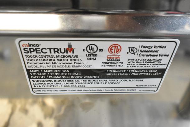 BRAND NEW Winco Spectrum EMW-1000ST Stainless Steel Commercial Microwave. 120V, 1 Phase. Model label detailing specs and certifications.