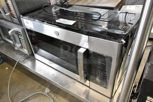 Brand new, scratch and dent 2025 GE JVM3160RF9SS stainless steel microwave, 120 volts, 1 phase, visible damage on top.
