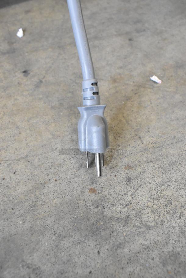 Power cord for GE JVM3160RF9SS microwave on concrete floor.