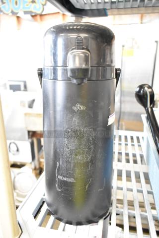 Black air pot, brand "Update," visible wear on surface, lever lid, ideal for beverages, auction includes two units.