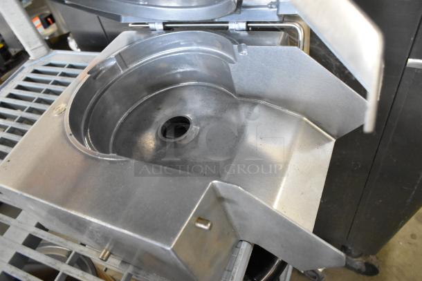 Metal commercial continuous feed head for food processor, in good condition, featuring a durable design and central feed opening.