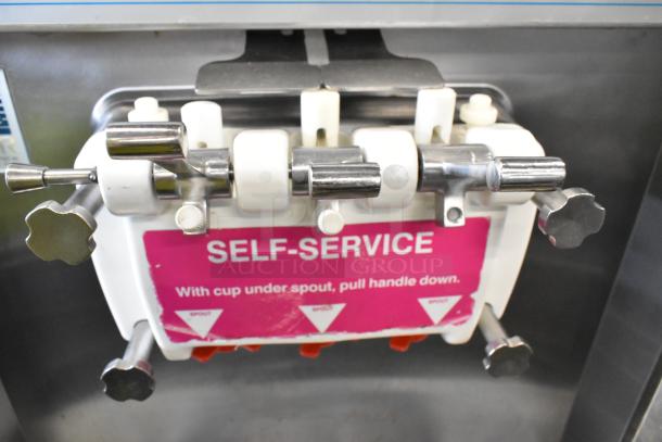 Taylor 339-27 stainless steel soft serve machine. Self-service spouts, twist flavor, on commercial casters. 208-230V, 1 phase.