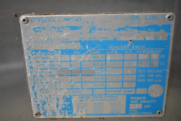 Taylor 339-27 Stainless Steel Soft Serve Machine, air-cooled, two flavors plus twist, commercial casters, worn label visible.