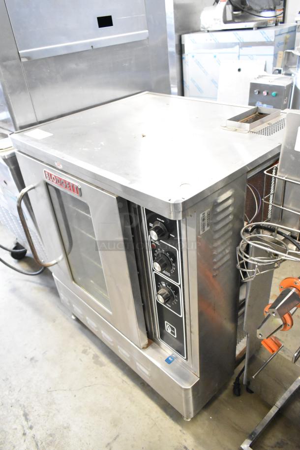 Blodgett stainless steel gas convection oven with view-through door, metal racks, and thermostatic controls. Excellent condition.