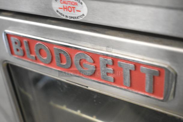 Blodgett stainless steel convection oven with view-through door, metal racks, thermostatic controls, and caution hot label.