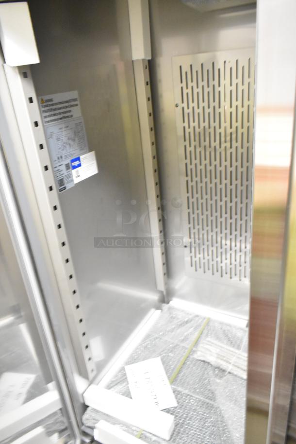 2023 Avantco 178SS2FHC 54" stainless steel reach-in freezer interior. Includes labels and protective packaging.