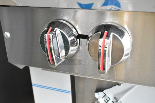 Chrome control knobs of the Southbend S361D 6-burner range with stainless steel panel, showing red accents.