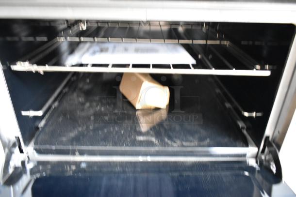 Interior view of new Southbend S361D 36" gas range oven. Contains shelving and packaging. 203,000 BTU, scratch and dent condition.