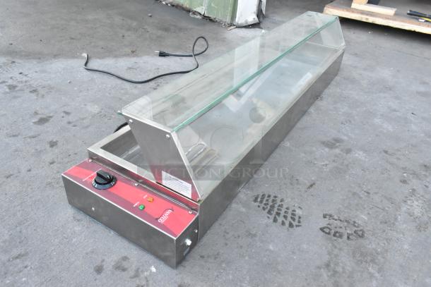 Brand new Avantco Bain Marie, stainless steel with glass top, visible control panel, minor scratches and dents.