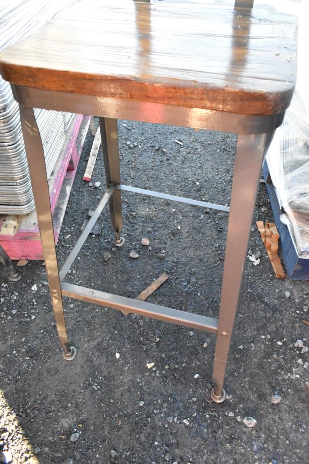 Metal bar height chair with wooden backrest and seat, sturdy design, suitable for various settings.