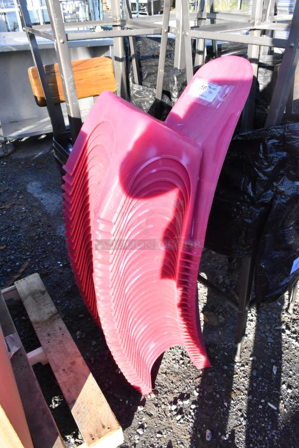 30 pink poly children's chairs in good condition, stacked. Each chair features durable, lightweight material.