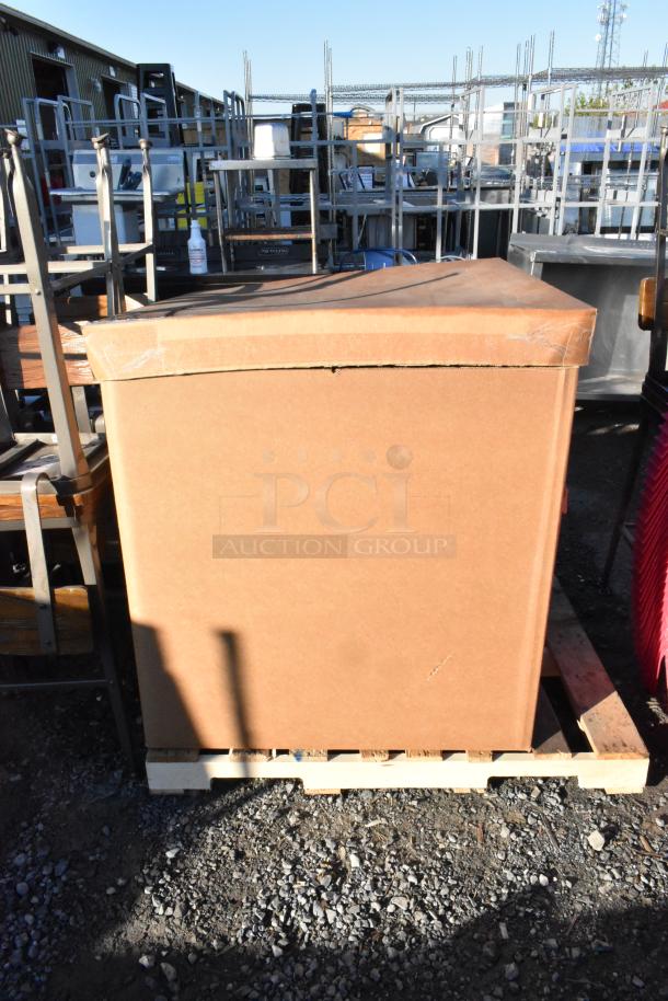 Pallet lot of various items including stainless steel drop-in bins and 2.25" white ramekins, on a wooden pallet.
