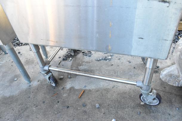 Krowne stainless steel commercial ice bin on commercial casters, showing light surface wear, ideal for bar use.