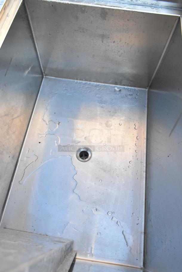 Krowne Stainless Steel Commercial Ice Bin, used condition, showing interior with drain hole and water droplets.