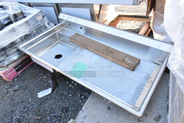 BRAND NEW SCRATCH AND DENT Regency 60" stainless steel dishtable, 16-gauge, sink left, visible denting, boxed parts included.